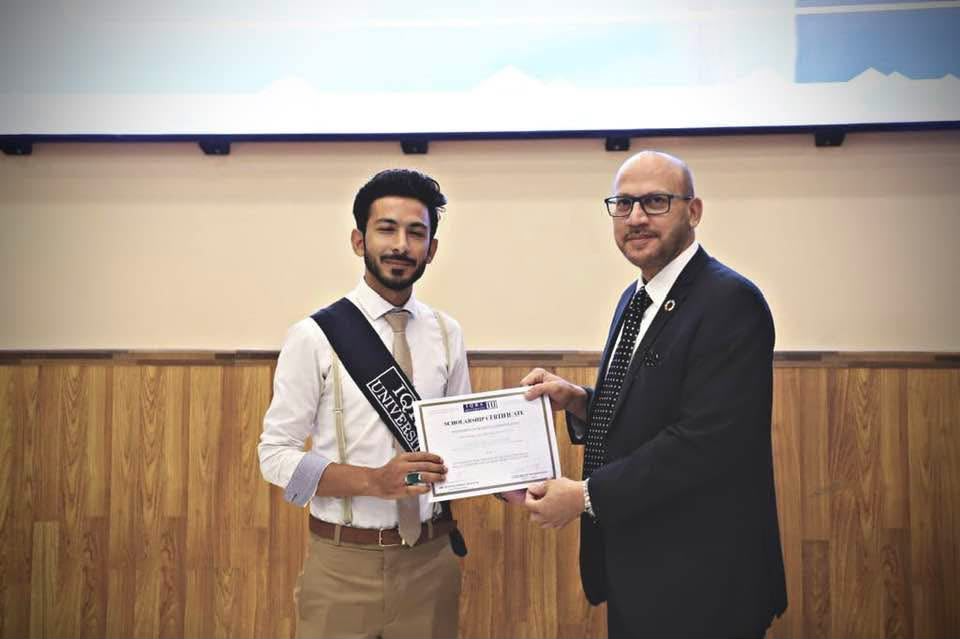 Zafar Abbas receiving a certificate at Iqra University